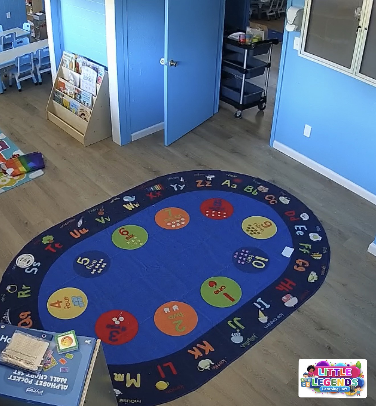 Classroom camera view of circle time rug and reading corner