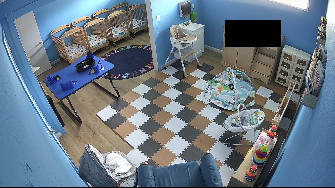 Infant room camera view with cribs and play area